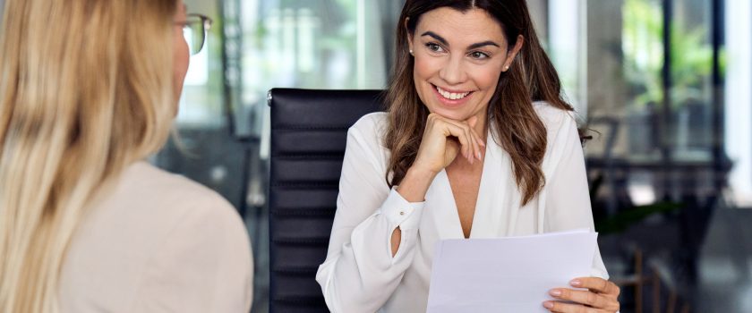 An HR professional interviews an applicant for a digital marketing position