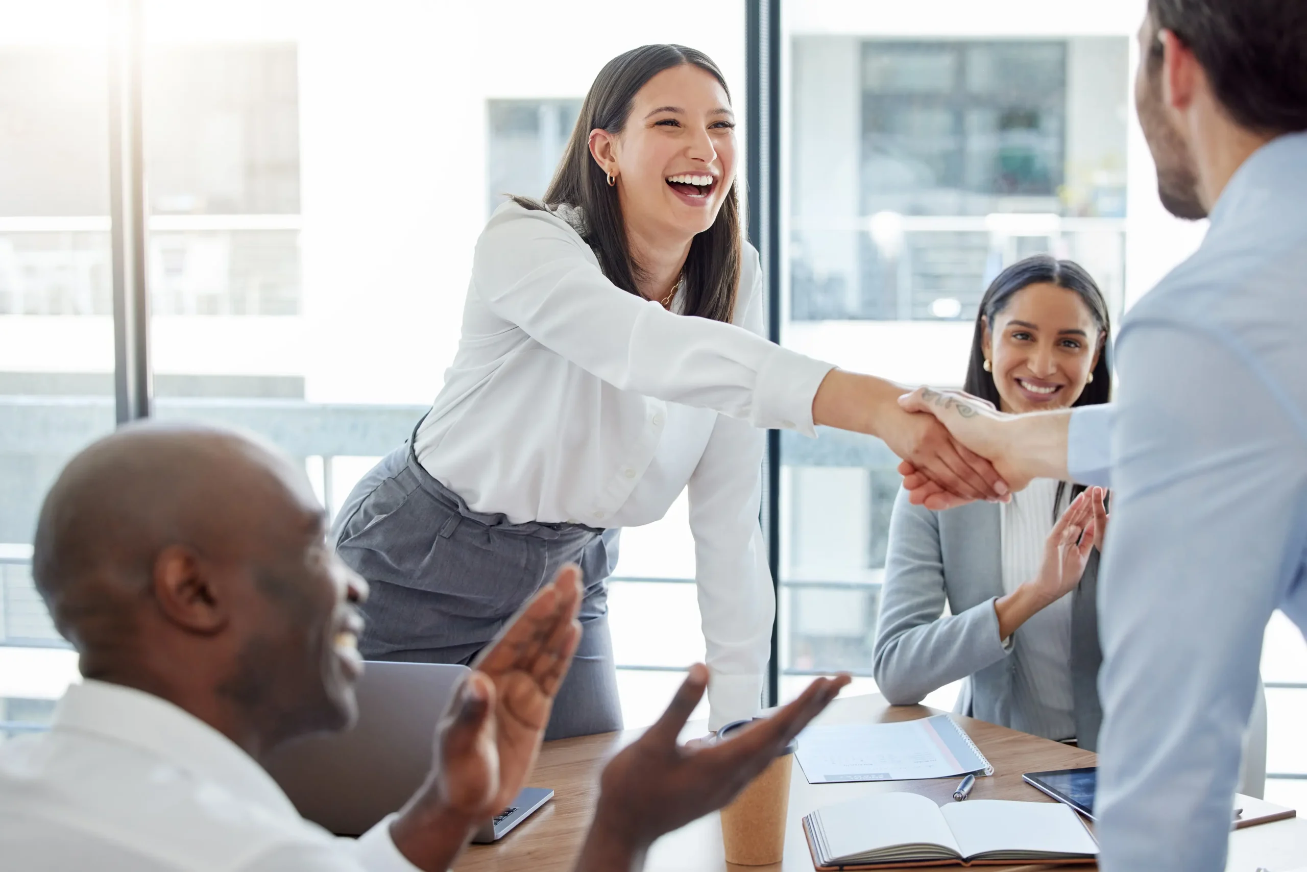 Recruiter and marketing executive shaking hands after a successful CMO hire.
