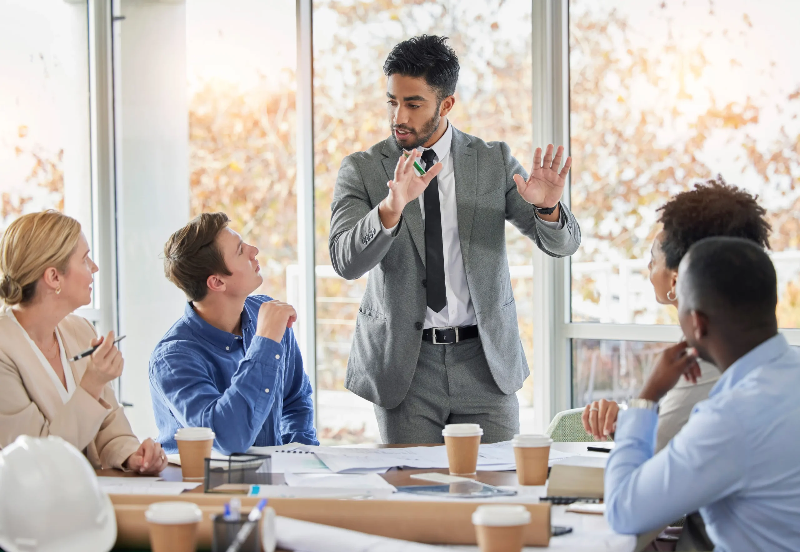 Chief Marketing Officer leading a strategy meeting with diverse executives.